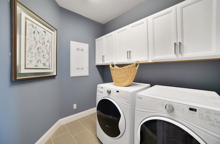 Chestnut laundry room with washer and dryer