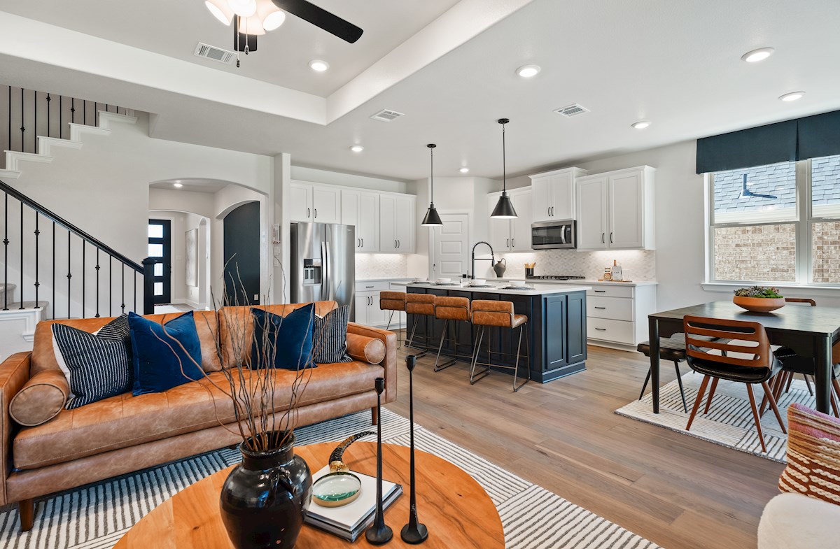 open great room with wood floors and ceiling fan