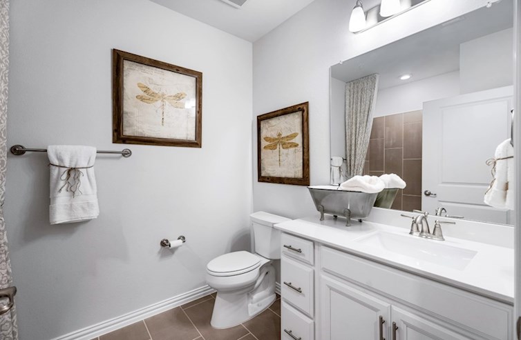 Dorset bathroom with white cabinets and white countertops