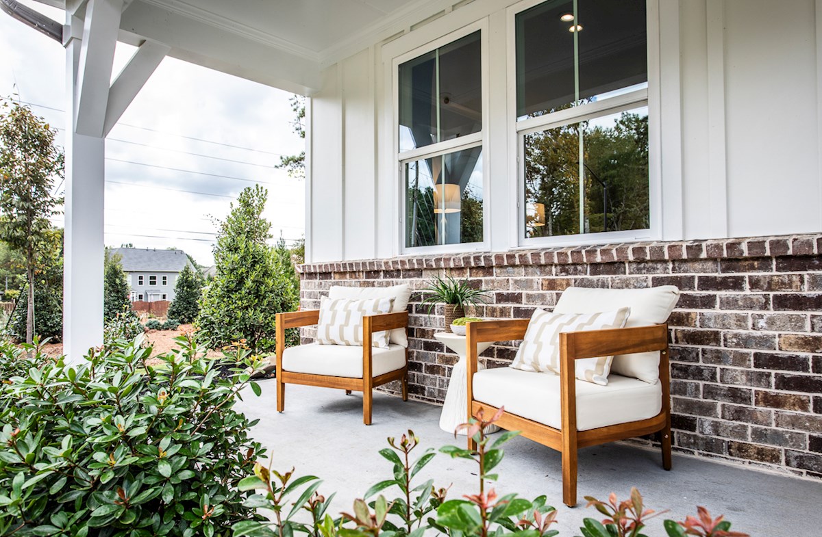 front porch with outdoor furniture & brick detail