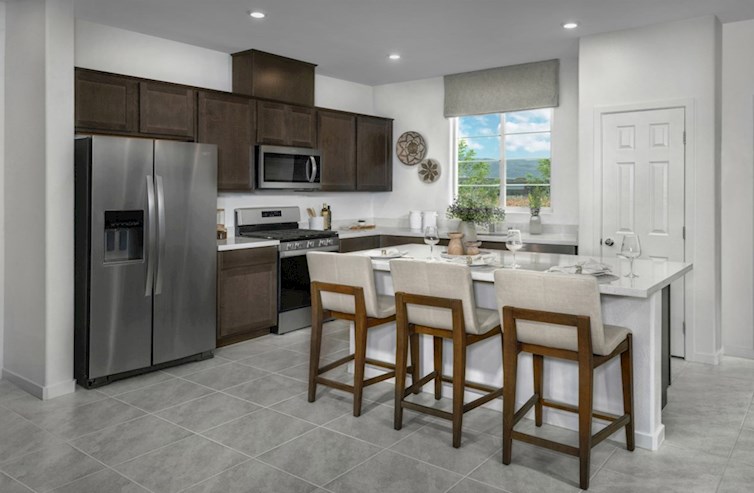 Griffin kitchen with dark cabinets and stainless steel appliances