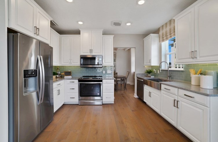 Chestnut kitchen with spacious countertops and stainless steel appliances