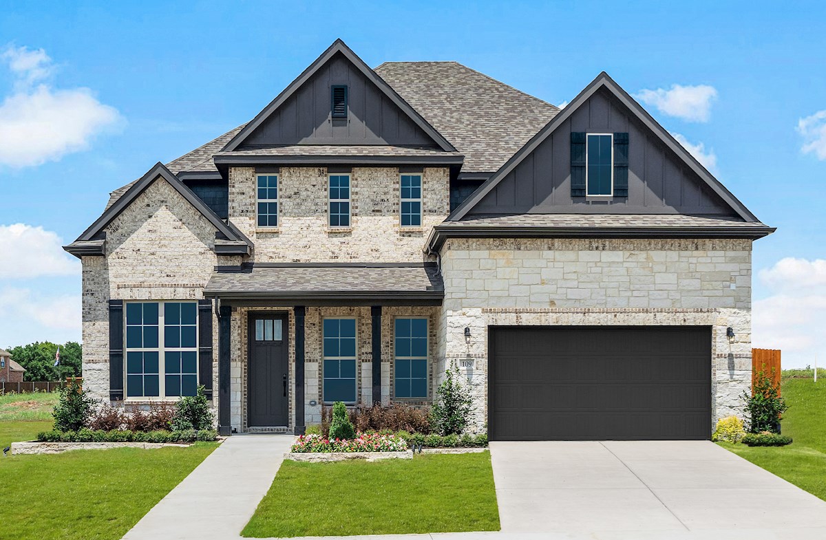 brick and stone exterior with grassy front yard