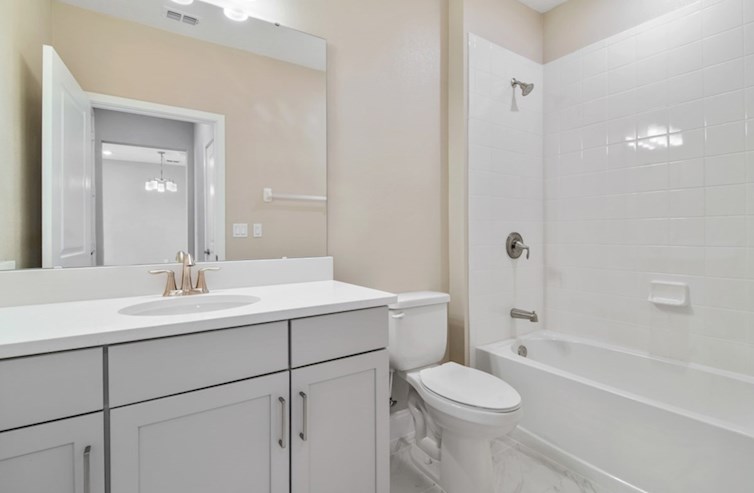 Aspen secondary bathroom with quartz countertops and tub