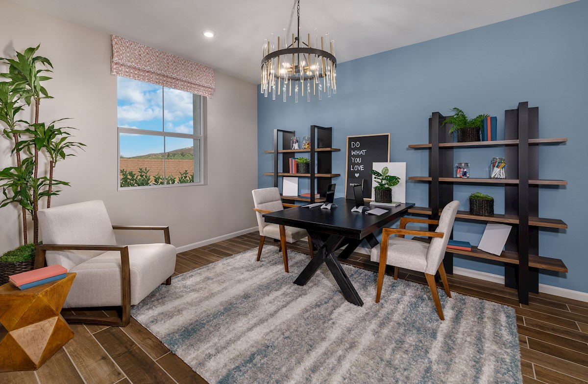 office with a blue accented wall and wood flooring