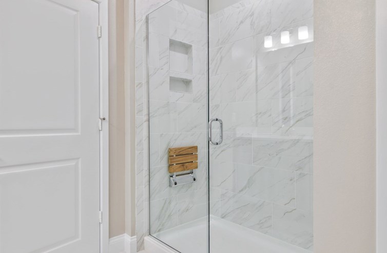 Aspen semi-frameless primary shower with folding seat