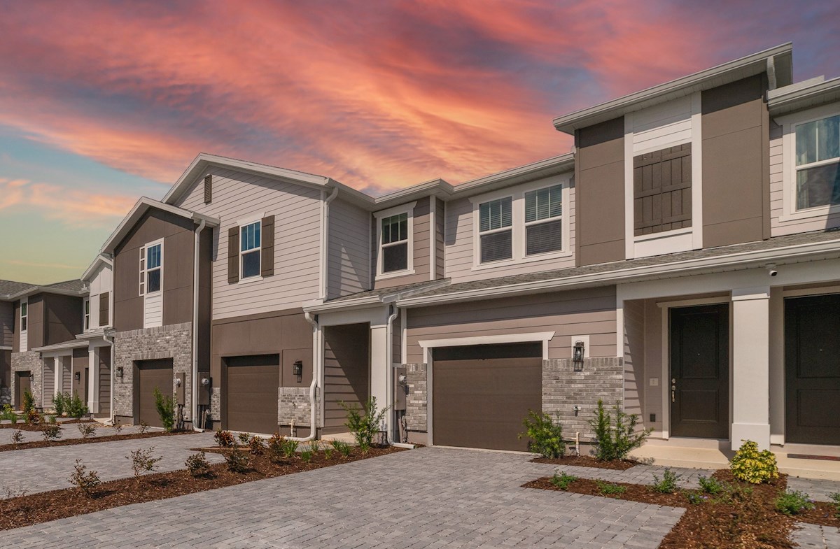 front exterior of townhome with accent shutters