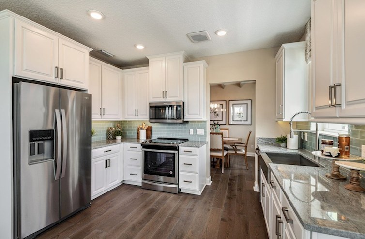 Chestnut chef-inspired kitchen with white cabinets and stainless appliances