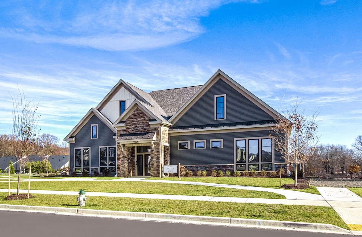 brand-new clubhouse with blue siding and stone