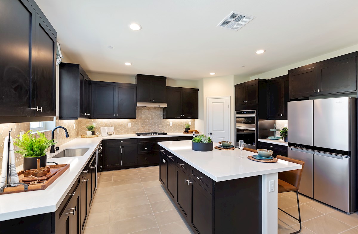 kitchen with dark cabinets and neutral backsplash