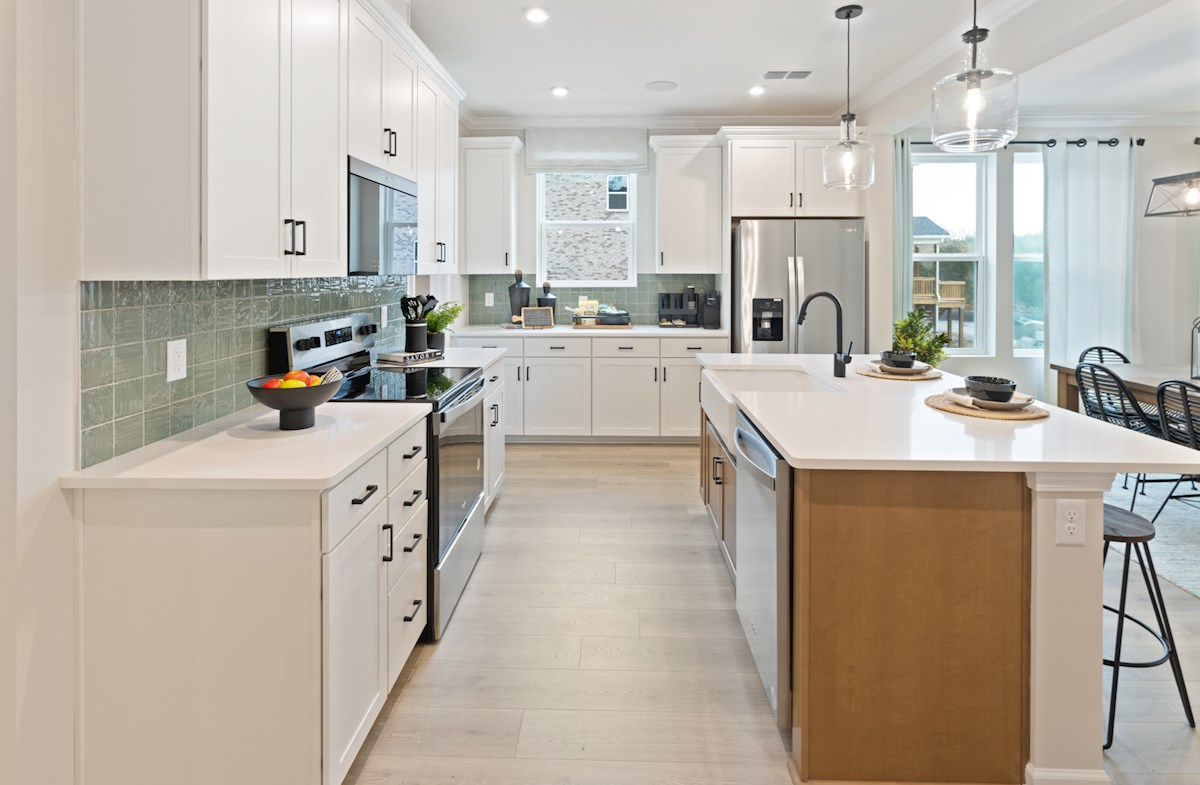 kitchen with white cabinets and a green backsplash