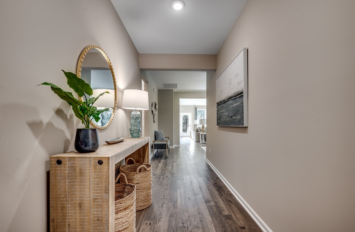 entryway with tan walls and hardwood floors