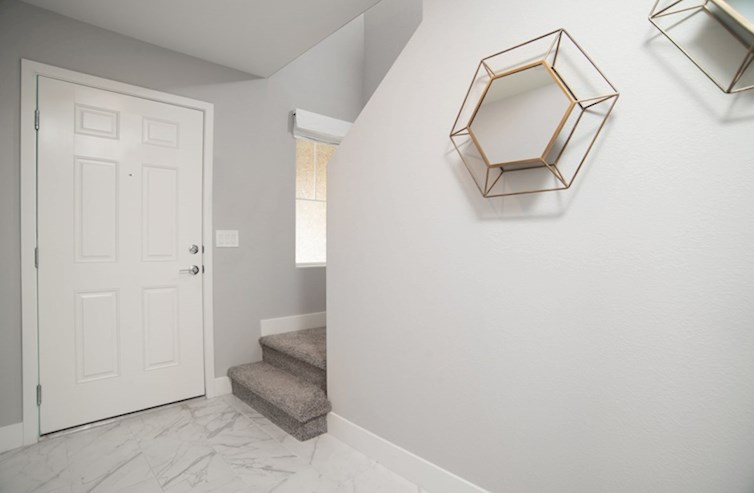 Bedford foyer with tile floor and decorative wall mirrors