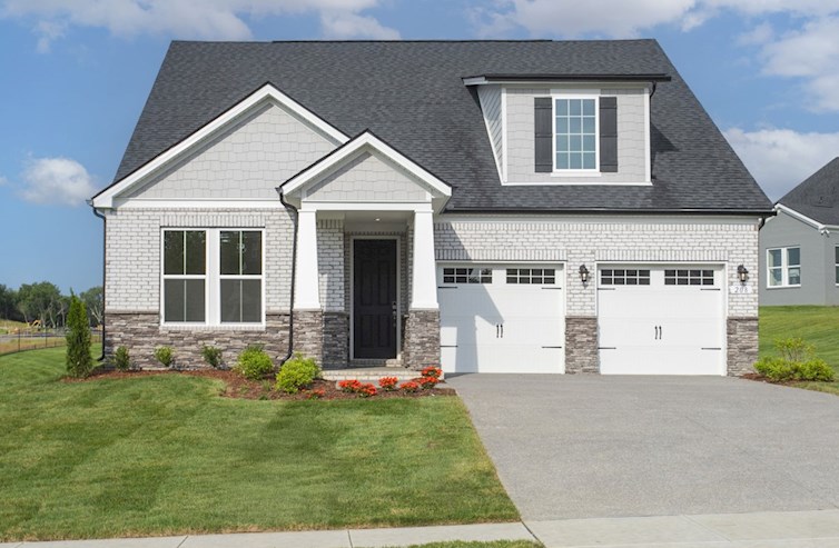Home exterior with white brick and 2-car garage.