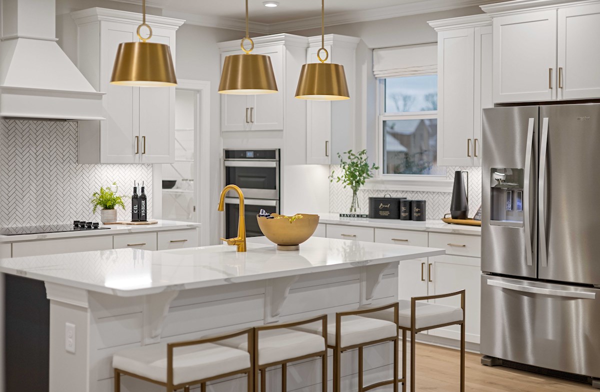 kitchen with white cabinets and gold accents