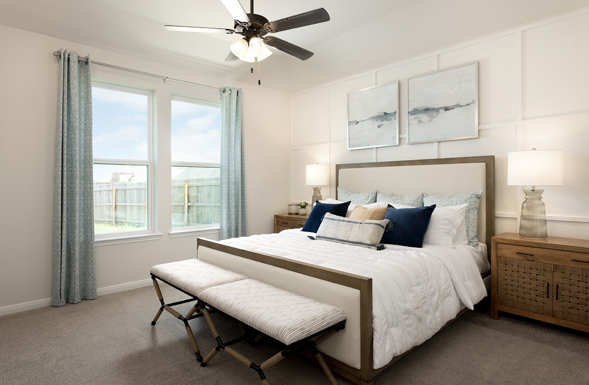 bedroom with accent wall, window & ceiling fan 