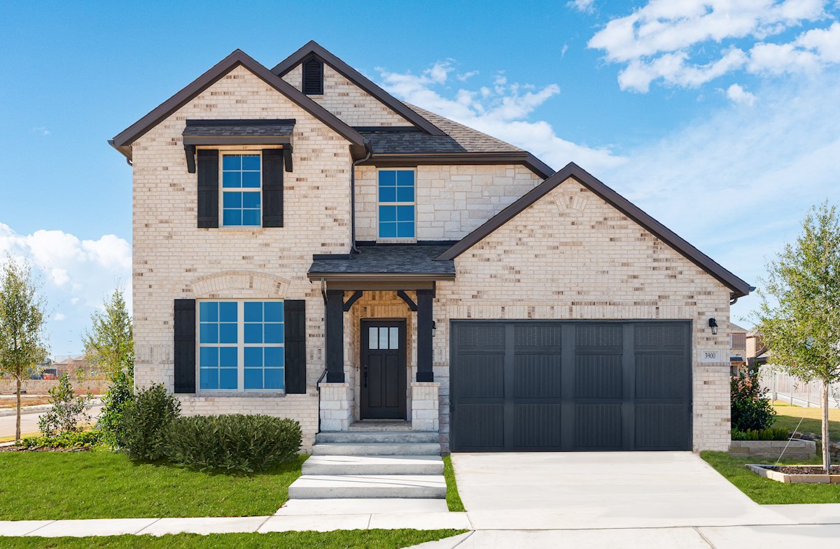 2-story home with brick exterior & window shutters