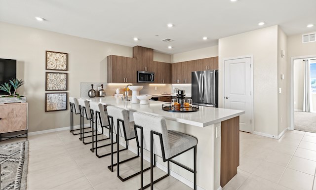 kitchen with 4 chairs brown modern cabinets and large countertop  For more information on this video, review content in slideshow, overview, and details & features section