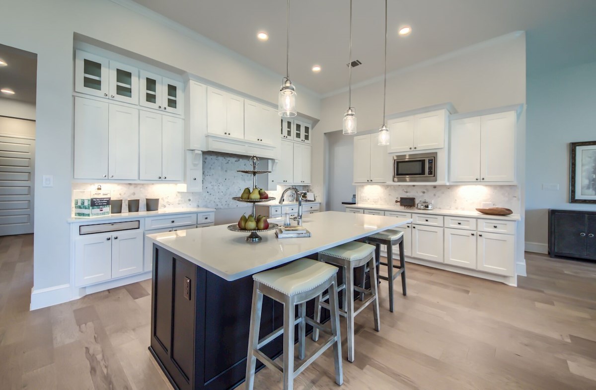 kitchen with white cabinets and a blue island
