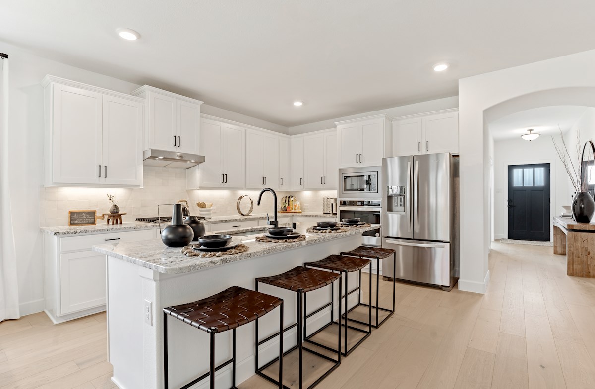 open kitchen with white cabinets and wood floors