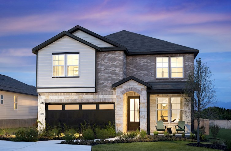 exterior with brick, stone & a covered porch 