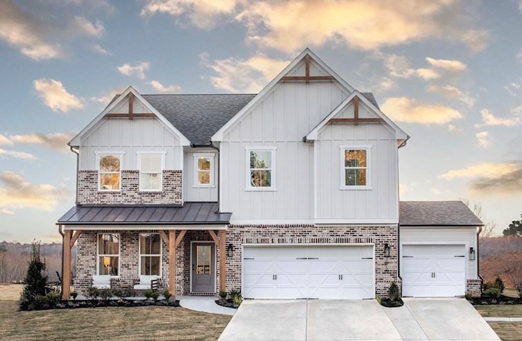 front of home with brick detail and 3rd car garage