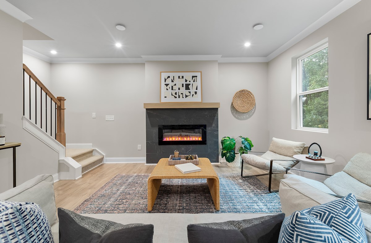 great room with fireplace and light plank flooring