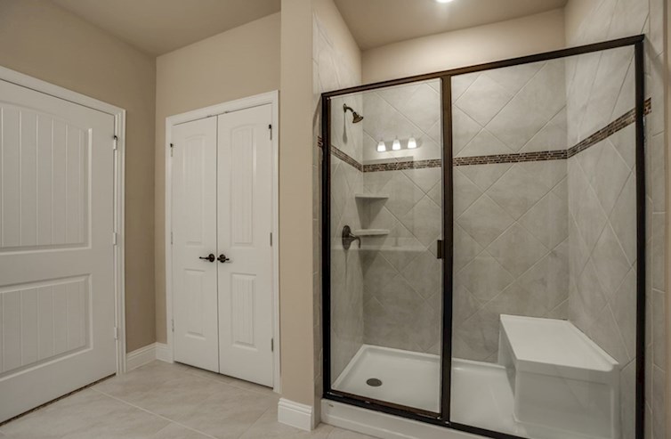 Sherwood primary bathroom with large walk-in shower with seat