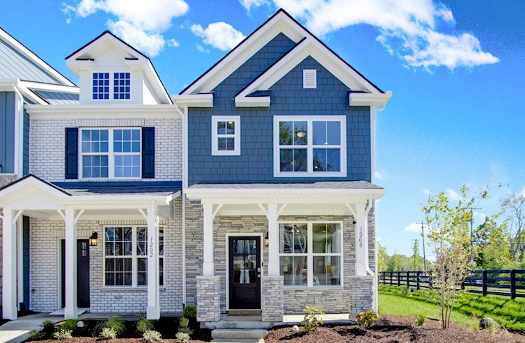 bright blue townhome exterior with stone base
