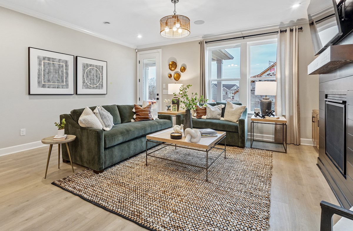 great room with a green couch and fireplace