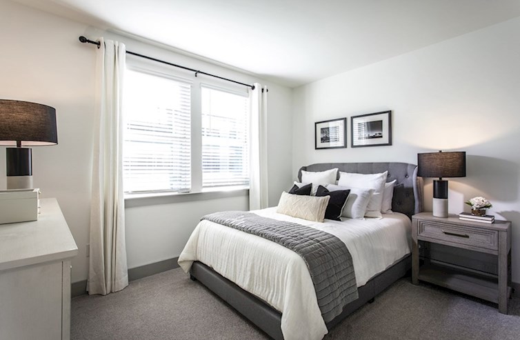 Sherwood secondary bedroom with natural light and neutral carpet