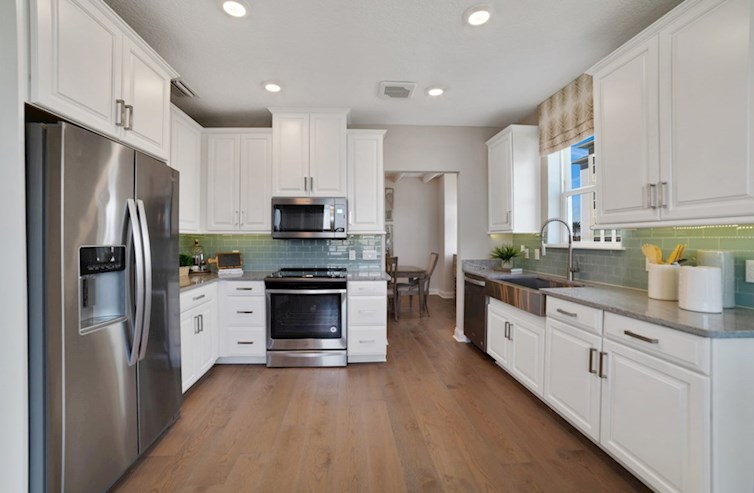 Chestnut chef-inspired kitchen with white cabinets and quartz counters