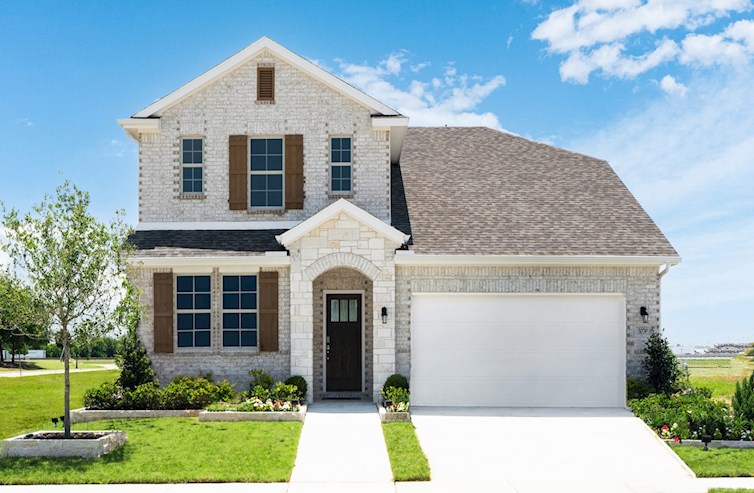 brick and stone exterior with tree in front yard