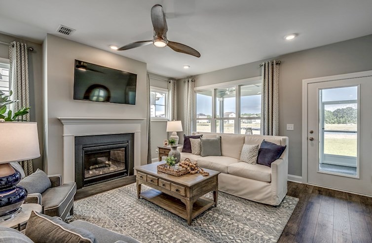 Hickory open-concept great room with a fireplace, area rug, ceiling fan, and seating