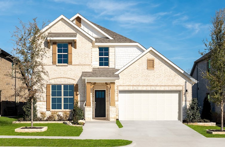 brick and stone exterior with tree in front yard