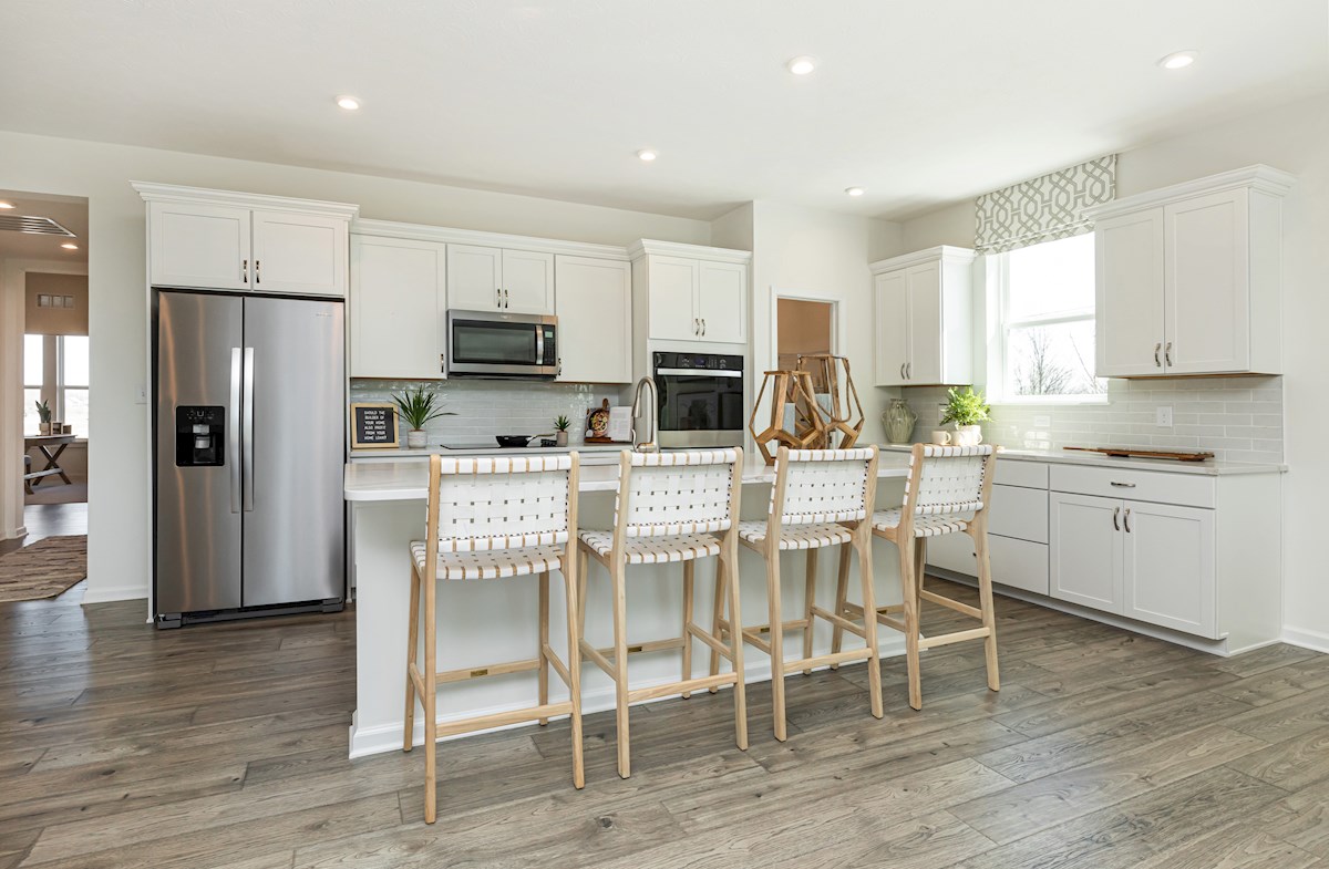 open-concept kitchen with white cabinets 