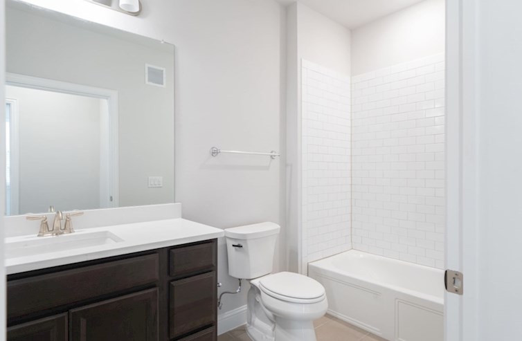 Clifton secondary bathroom with bathtub and tile floor