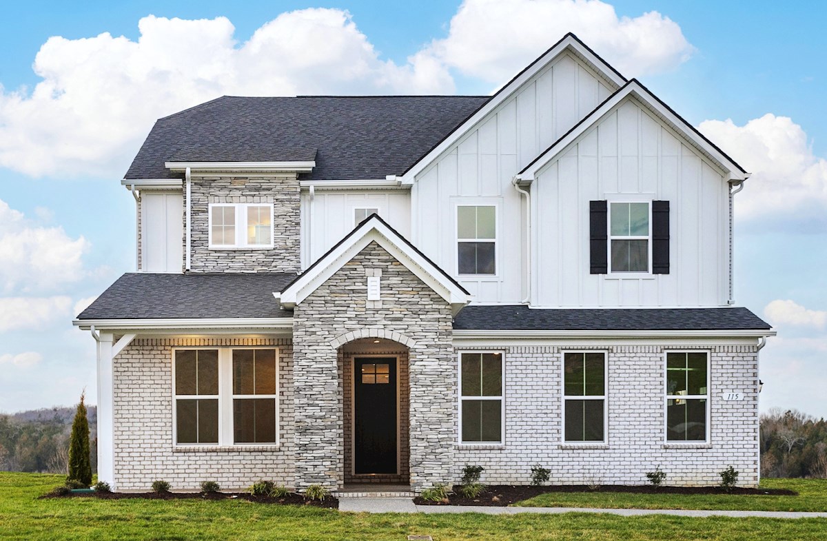 home exterior with brick and a covered porch