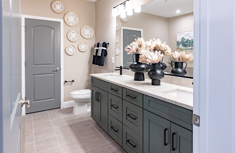 Sherwyn green cabinets and dual vanities in the primary bath