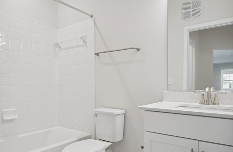 Denmark secondary bathroom with a tub, 6"x6" wall tile, iced white quartz countertops, white shaker cabinets, and rectangular porcelain undermount sink