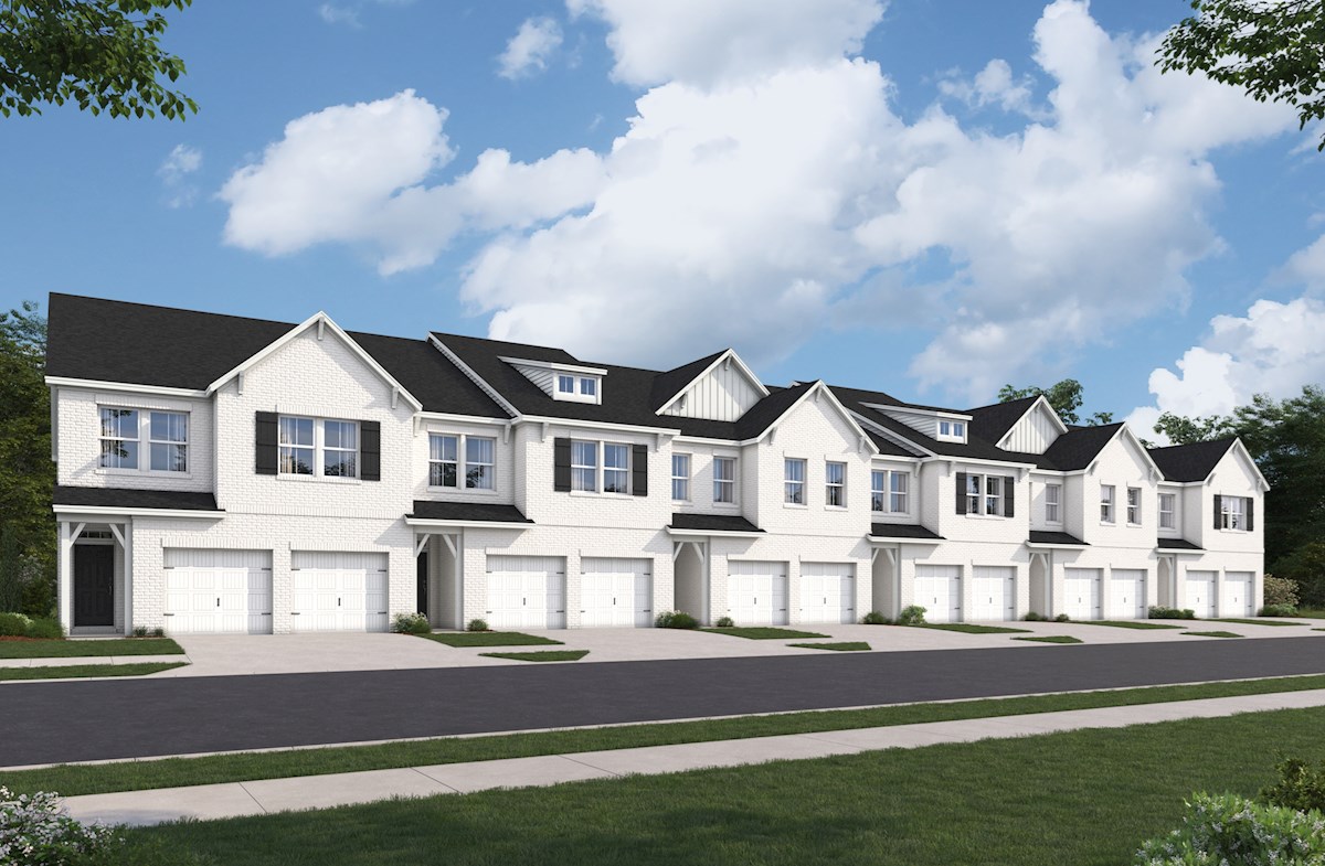 white brick townhome exterior with garages