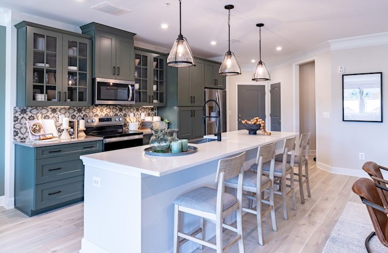 Sherwyn kitchen with green cabinets and a white island